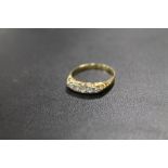 AN UNMARKED YELLOW METAL FIVE STONE DRESS RING - APPROX WEIGHT 2 G