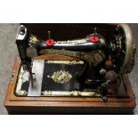 A VINTAGE CASED SINGER SEWING MACHINE