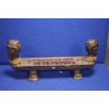 AN UNUSUAL CARVED TRIBAL RACK WITH HEAD TO EACH END EACH WITH A LIZARD ON TOP