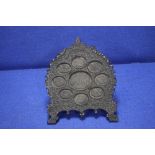 AN ANTIQUE ANGLO INDIAN CARVED HARD WOOD STAND FOR MINIATURES, WITH 9 OVAL APERTURES FITTED WITH