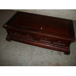 A LARGE COFFEE TABLE WITH STORAGE DRAWERS