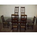 A DARK OAK EXTENDING DINING SET TABLE WITH 8 CHAIRS