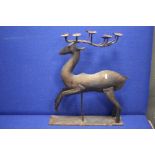 A METAL CANDLE HOLDER IN THE FORM OF A DEER