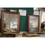 A PAIR OF FRAMED MIRRORS 107 CM X 63 CM