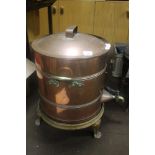 A LARGE COPPER TEA URN ON CAST IRON STAND