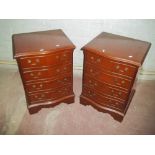 A PAIR OF REPRODUCTION SERPENTINE FRONTED CHEST OF DRAWERS