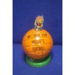 A 1966 WORLD CUP WILLIE LOVELLS TOFFEE TIN IN THE FORM OF A FOOTBALL, TOPPED BY A WORLD CUP WILLIE