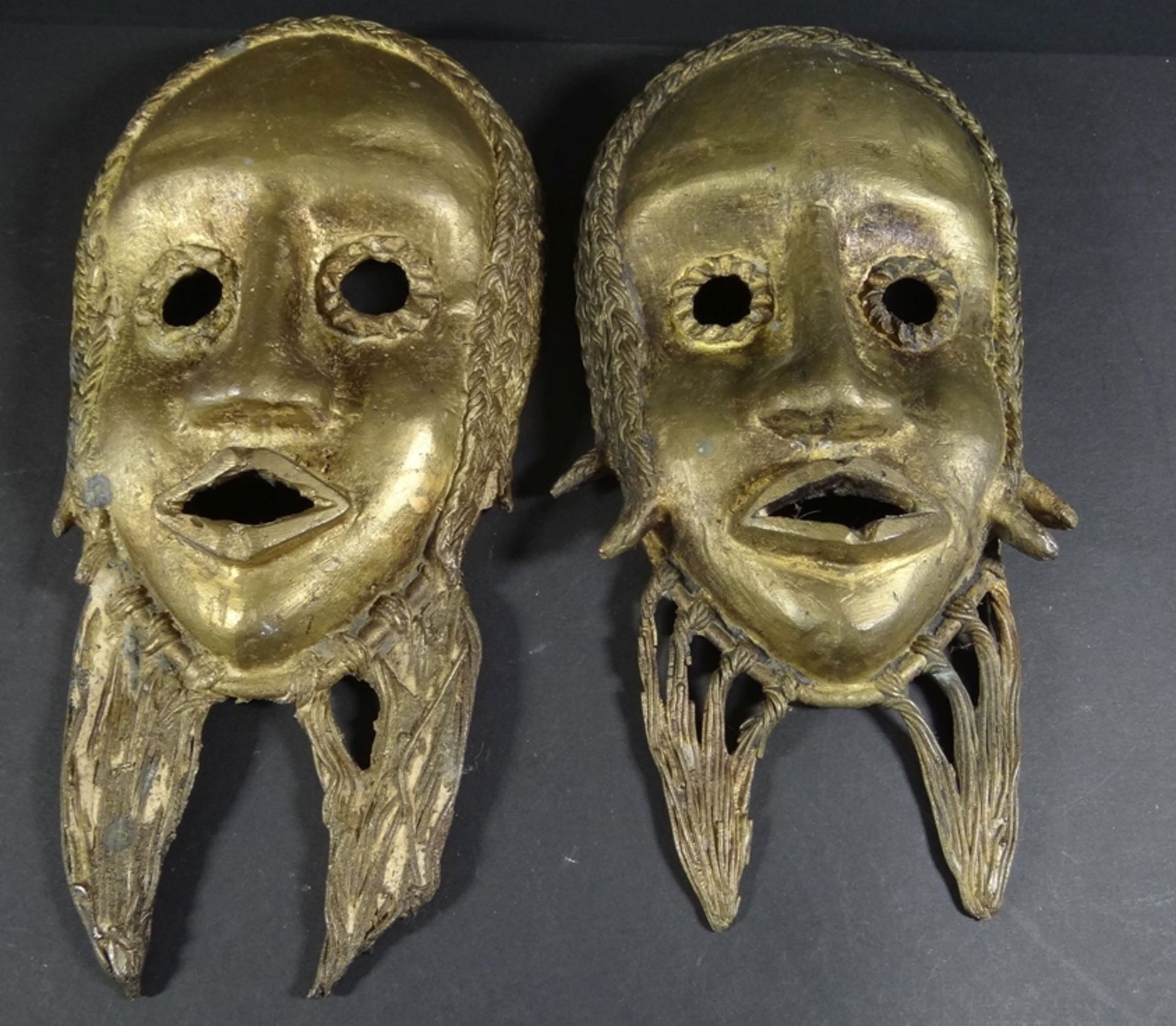 2 Ashanti-Bronzemasken, ca. 28x13 cm