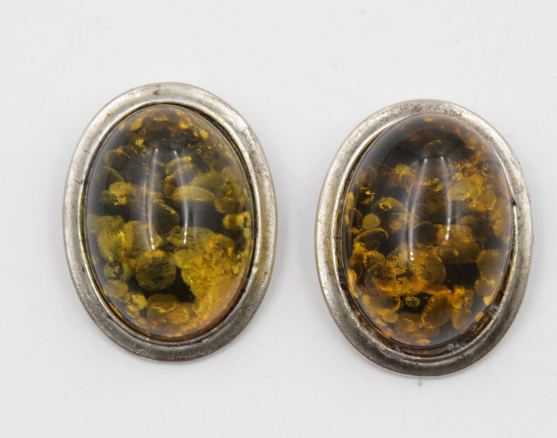 Paar Ohrclipse, wohl Kunststoff in 925er Silberfassung, zus. 12,5gr., 3 x 2,2cm.