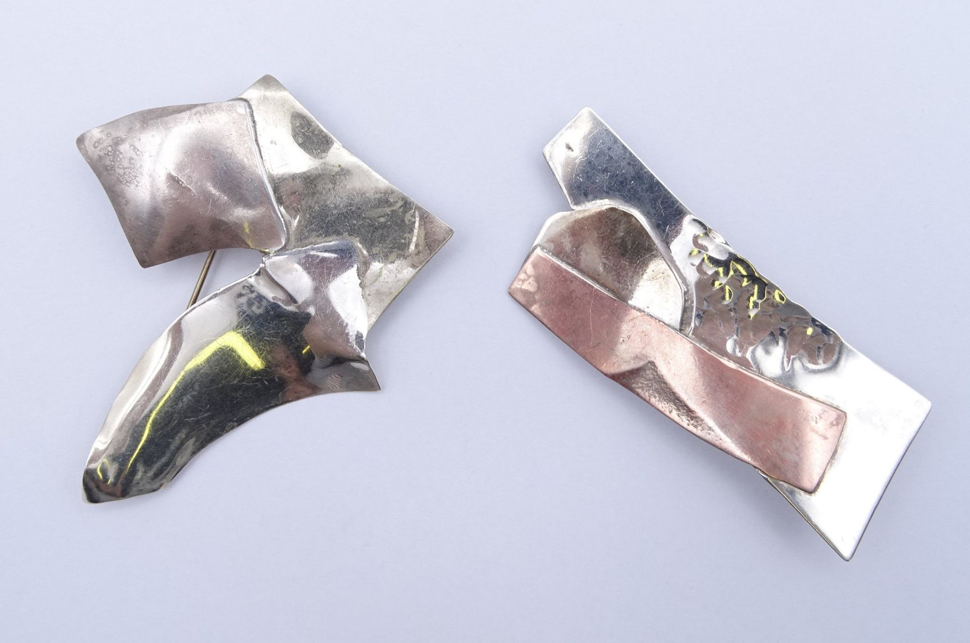 2 Tricolor-Silberbroschen, 925/000, "Handmade", beide gest., ca. 7 x 3 und 6,5 x 6 cm, zus. 20 gr.,