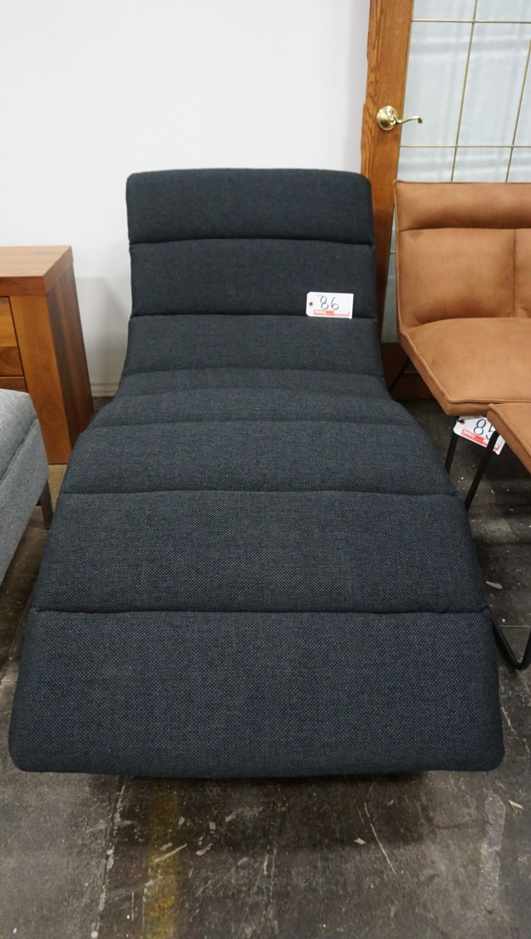 LOT - BLACK FABRIC UPHOLSTERED LOUNGE CHAIR - 64" X 29"