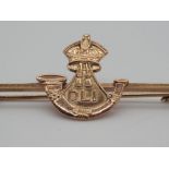 A 9ct yellow gold infantry bar badge