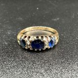 A 9ct yellow gold diamond and sapphire ring