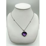 An 18ct white gold Amethyst and diamond pendant