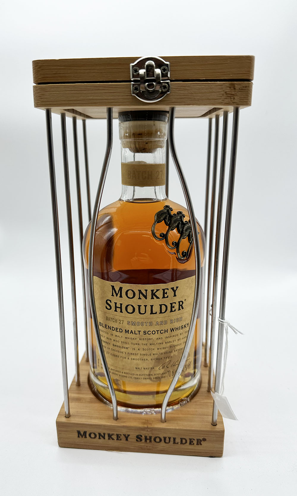 A bottle of Monkey Shoulder whisky in a cage