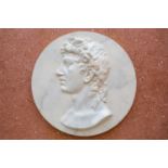 A late 20th century simulated marble plaster relief roundel depicting the profile bust study of