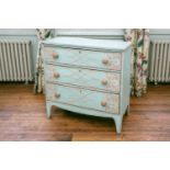 A 19th century painted and simulated pine chest of three drawers with Gothic tracery, on shaped