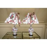 A pair of Ironstone style 'Chinese Rose' decorated baluster pottery table lamps, with pleated chintz