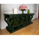 An early 20th century ebonised sideboard with a plain frieze and brushing slides and nine flat