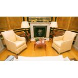 A pair of Edwardian style scroll back easy armchairs with stuff over upholstery and loose saving