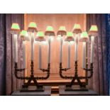 A pair of 20th century five sconce black iron candelabra table lamps, each with faux candles and