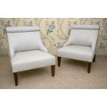 A pair of Edwardian style scroll back slipper chairs on square tapering supports. (2) 64cm wide x