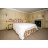 A floral chintz upholstered serpentine topped double headboard, together with matching valence. (