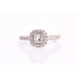 A Goldsmith 18ct white gold diamond set engagement ring, with a central four claw set princess cut