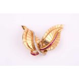 A French yellow metal ruby and diamond brooch, of double leaf form set with 8-cut diamonds and