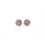 Pair of diamond cluster earrings, each with nineteen brilliant cuts claw set to white precious metal