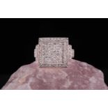 A diamond set tablet ring, illusion set with princess cut diamonds and pave set round brilliant