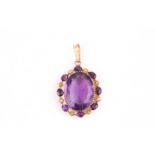 A oval amethyst and seed pearl pendant, set with a 25x20mm oval amethyst surrounded by further