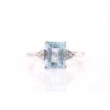 An 18ct gold aquamarine and diamond ring, with a claw set emerald cut aquamarine of approximately