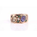 A sapphire, peridot, diamond and emerald bombe style ring, consisting of a rub-over set oval
