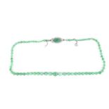 A jade bead necklace, circa 1930, beads graduated from 4mm to 9.3mm diameter, with a navette shape