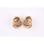 A pair of solid knot earrings, made from yellow and white metal loops stamped 'Italy K18' with