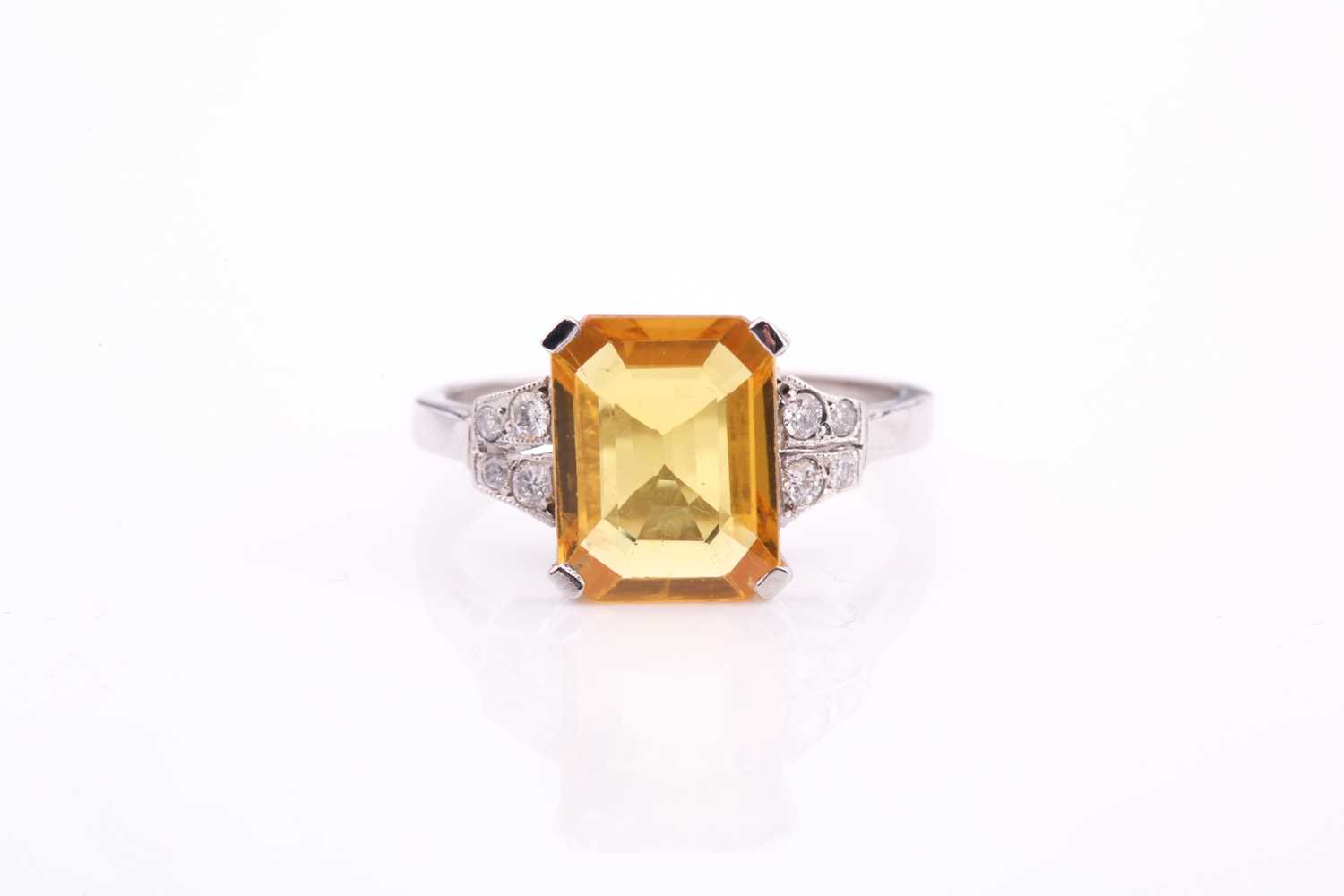 A yellow sapphire and diamond ring, the 10.5x8mm yellow sapphire with an estimated weight of 3.20ct,