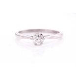 A solitaire diamond ring, the round brilliant cut diamond, approximately 0.69cts, set in white metal