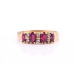 An 18ct yellow gold, ruby and diamond eternity ring, set with graduating marquise cut rubies