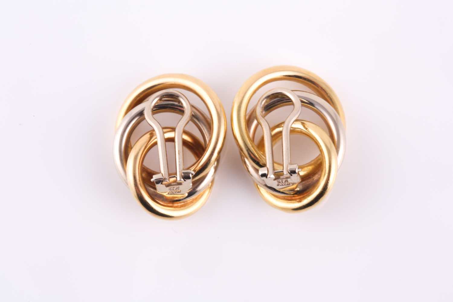 A pair of solid knot earrings, made from yellow and white metal loops stamped 'Italy K18' with - Image 3 of 3