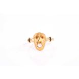 An unusual novelty yellow gold monkey head ring, the animal holding an old cut diamond in its