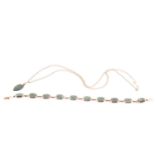 A lot consisting of a jade set bracelet and pendant, the bracelet has ten articulating sections