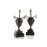 A pair of patinated bronze two handle urn form table lamps, 19th century and later, with gadrooned