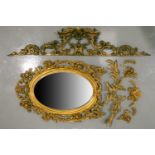 A 19th-century Venetian style carved, pierced wood oval wall mirror with florid scrolling frame,