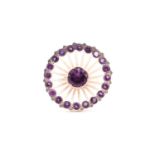 A large dress ring, centred by a collet set amethyst, within a high stalk set border of smaller