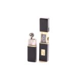 An art deco black enamel and gold plated pocket lighter and hand-wound travel clock. Engraved with A