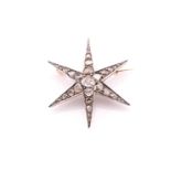An Edwardian white and rose metal star brooch set with mixed-cut diamonds with an estimated weight