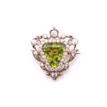 A Victorian peridot and diamond triangular shape brooch, circa 1890, the central triangular step-cut