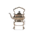 A silver kettle on stand of half reeded boat form, the domed cover with ebonised rectangular