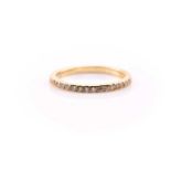 A yellow metal full eternity diamond ring, set with round brilliant cut diamonds of an estimated